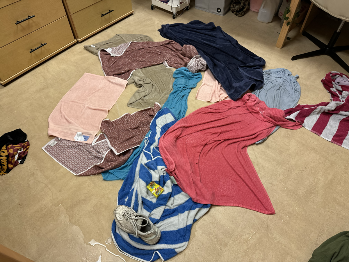 Towels line the floor to soak up floodwater in room 301A of Falls Hall Friday, Sept. 13.