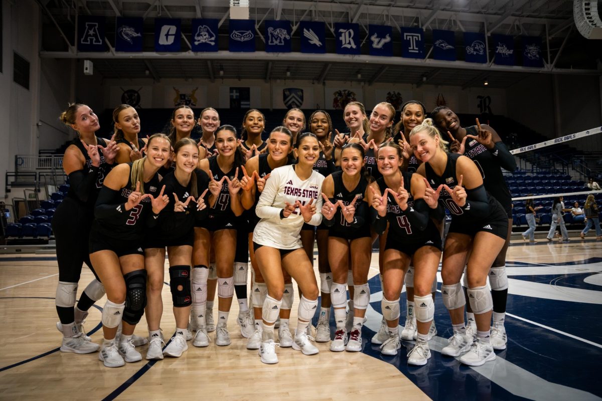 The Texas State volleyball team poses for a photo following its victory over Houston Christian at the Rice Invitational, Friday, Aug. 30, 2024, at Tudor Fieldhouse in Houston. 