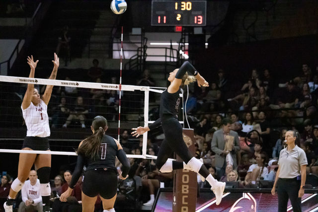 Texas State redshirt sophomore outside hitter Samantha Wunsch (8) spikes the ball over the net towards Troy. Friday, Oct. 4, 2024, at Strahan Arena.