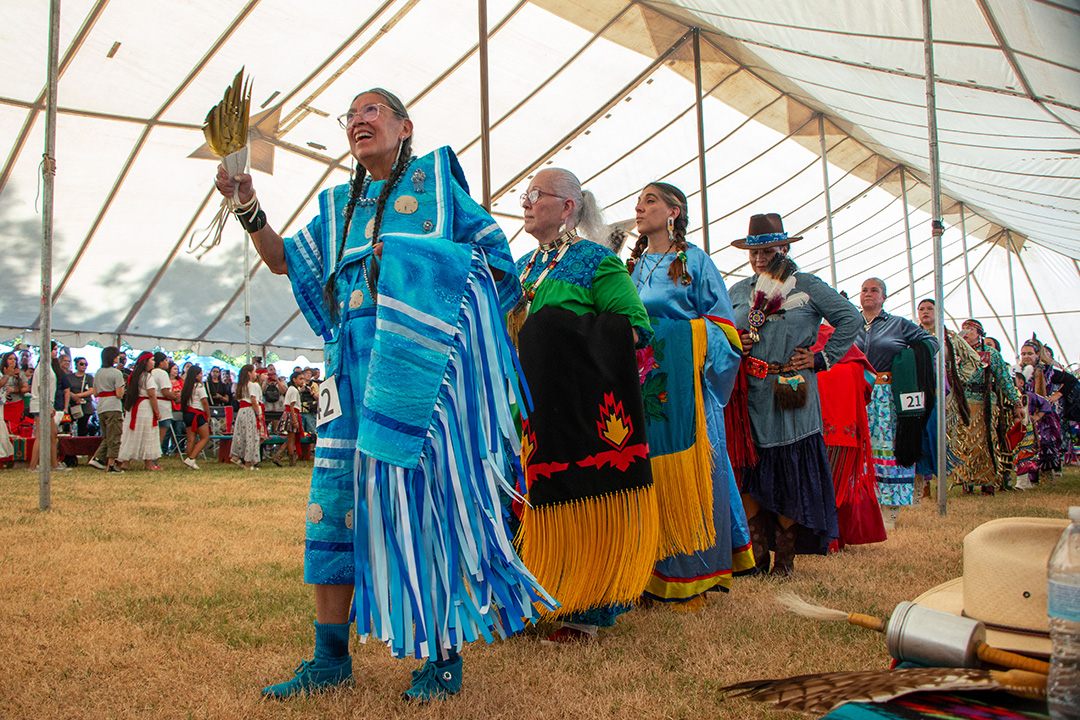 Native American cloth dancers dance in line during the grand entry at the Sacred Springs Powwow, Saturday, Oct. 5, 2024, near the Meadows Center. People from all over the state traveled to attend the two-day powwow.