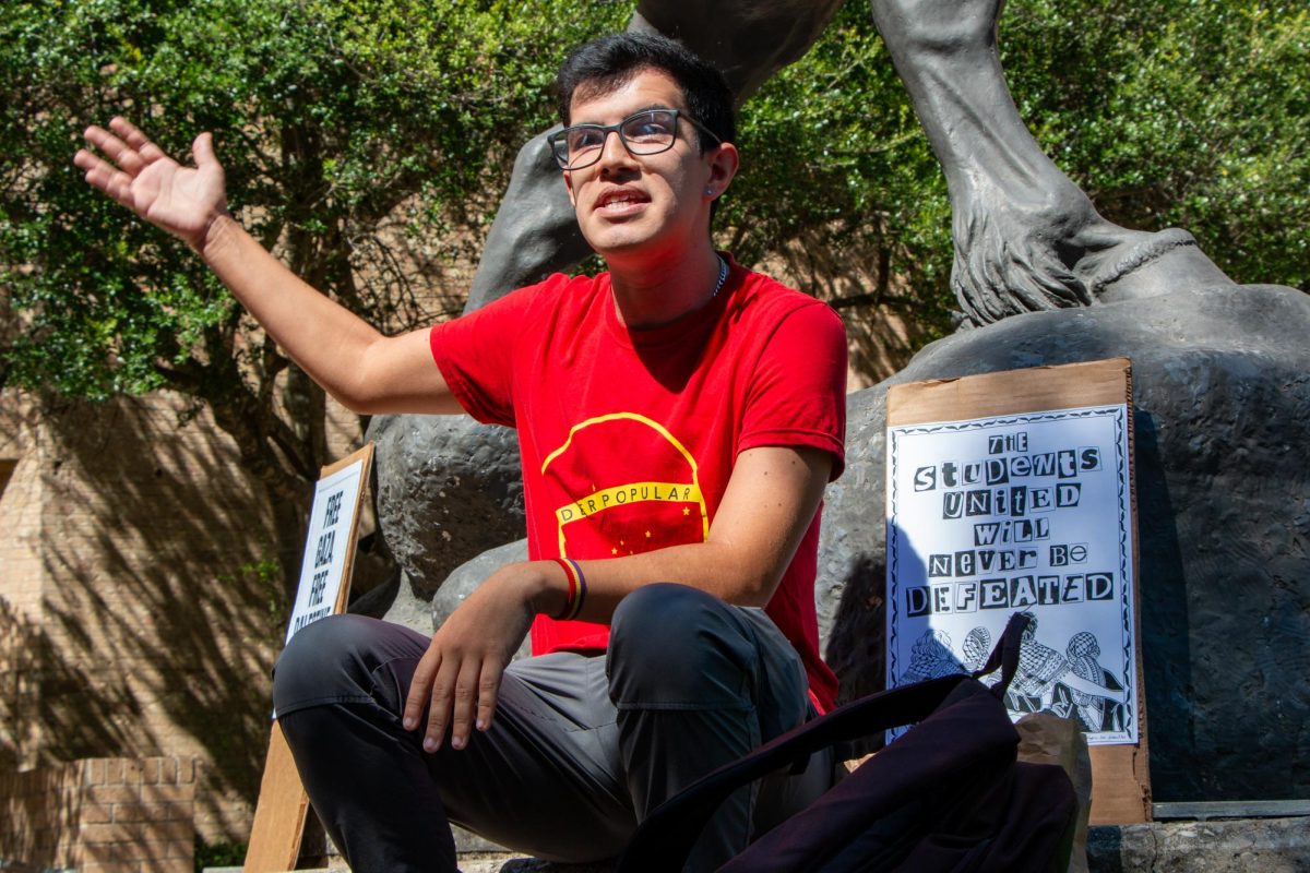 History graduate student Louis Osorio addresses protesters rallying for Palestine and Lebanon at the Stallions on Tuesday, Oct. 1, 2024, on The Quad. The protesters began at the Stallions then marched to the LBJ Student Center to object against visiting politicians participating in the Our Fight, Our Future Rally.