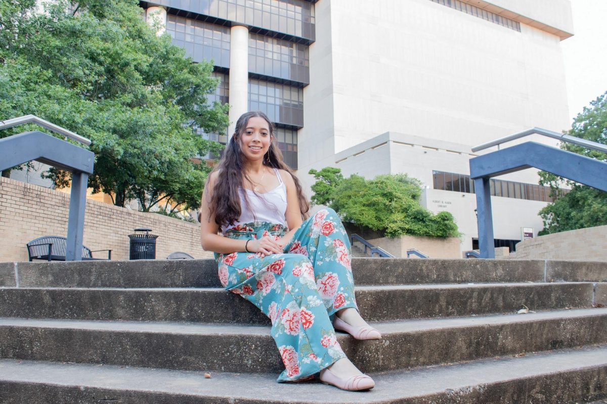 Education senior Fatima Hernandez poses below the stairs of Alkek Library, Sunday, Oct. 6, 2024, at Texas State.