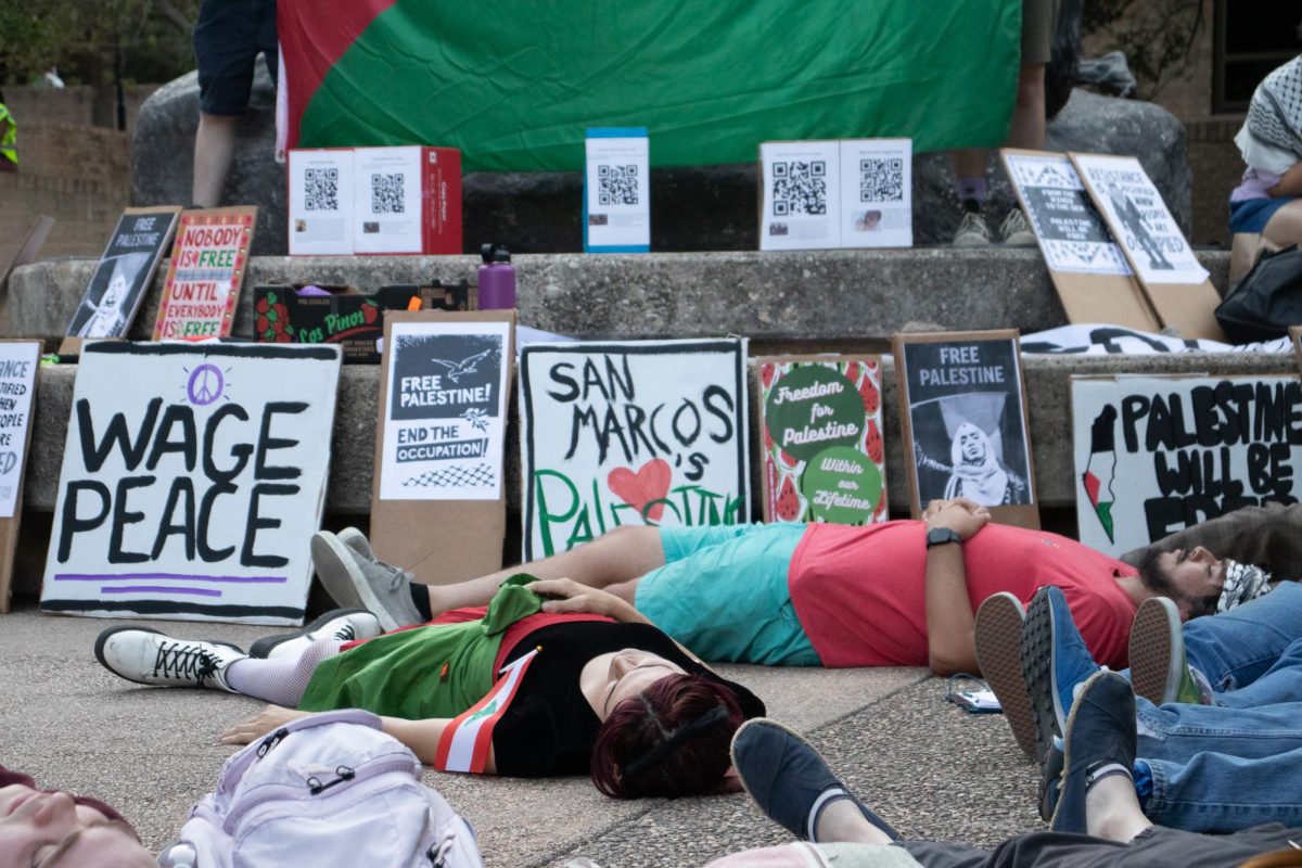 Participants of the Palestine Solidarity Committee's protest participate in a die-in to show solidarity with those who have been killed in Palestine. Tuesday, Oct. 8, 2024 at the Fighting Stallions Statue located in the Quad.