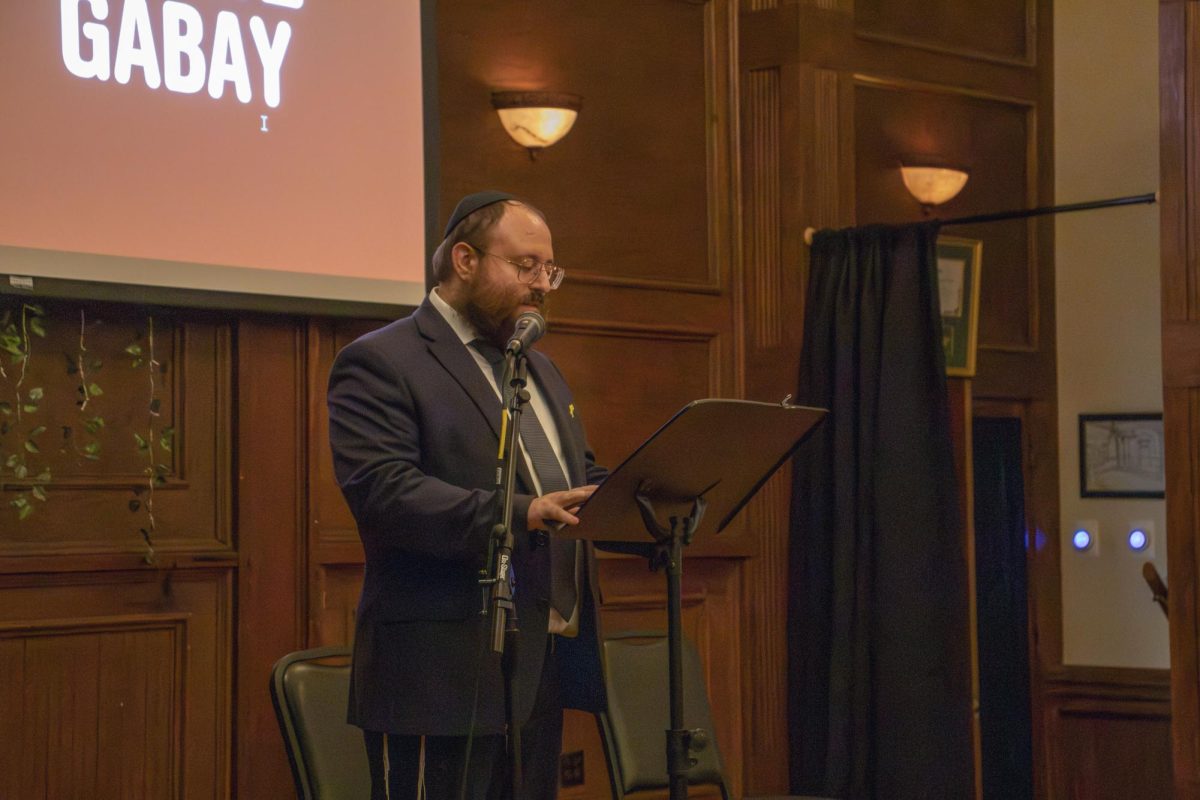 Rabbi Ari Weingarten introduces the speakers Texas State President Kelly Damphousse and Nova survivor Sagi Gabay for the October 7th memorial held by Chabad Texas State University, Chabad San Marcos and Faces of October Seventh, Monday, Oct. 14, 2024, at the Price Center and Garden.