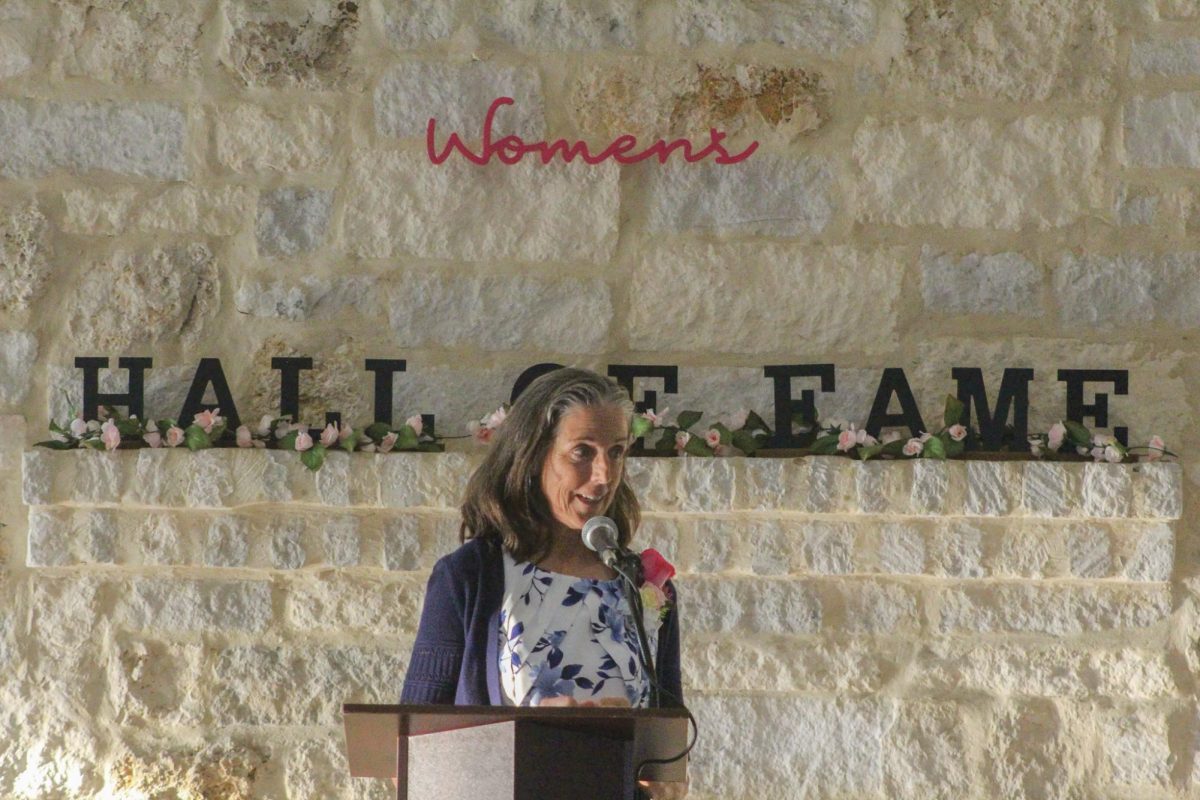 New 2024 inductee Melanie Howard stands at a podium to accept her award after 35 years of volunteering, Thursday, Oct. 3, 2024, at Pauline Espinoza Community Hall in San Marcos.