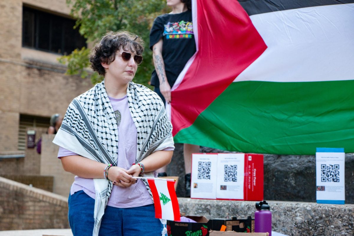 Anthropology masters Manar Naser tears up while speaking about family in Palestine during a protest on Tuesday, Oct. 8, 2024, at the Stallions.