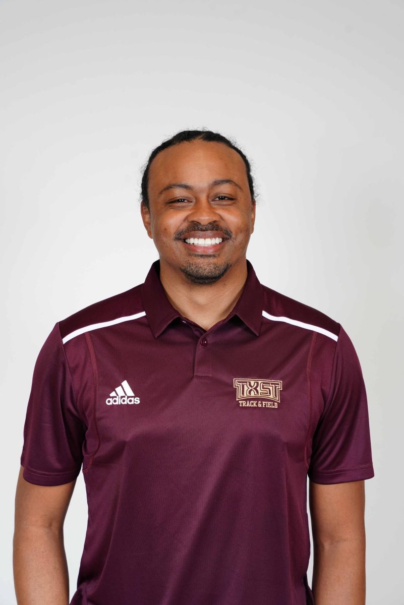 Aries Merritt poses for a headshot as an assistant coach and director of operations for the Texas State track and field team in sprints, hurdles and relays. 