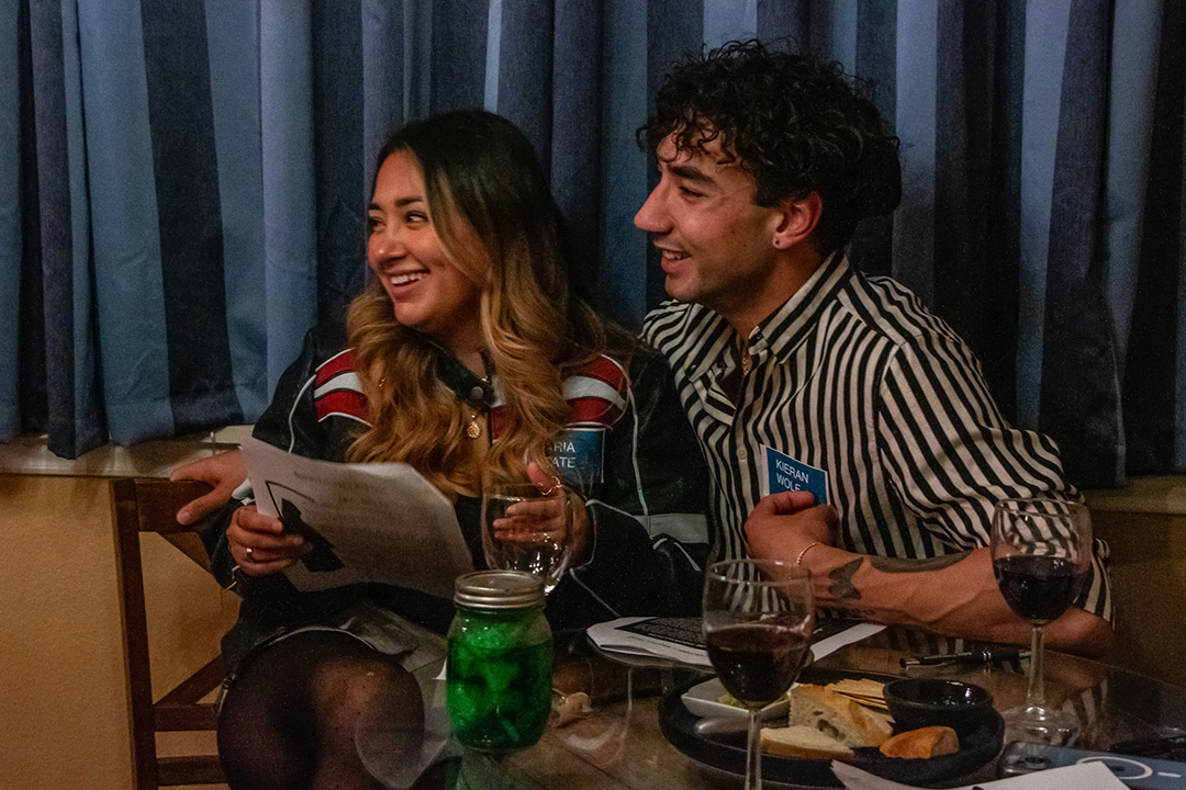 Nora Guerra (Left) and Joshua Spear (Right) watch the introduction to Wineaux's Halloween Murder Mystery Party, Saturday, Oct. 26, 2024, at Wineaux. 