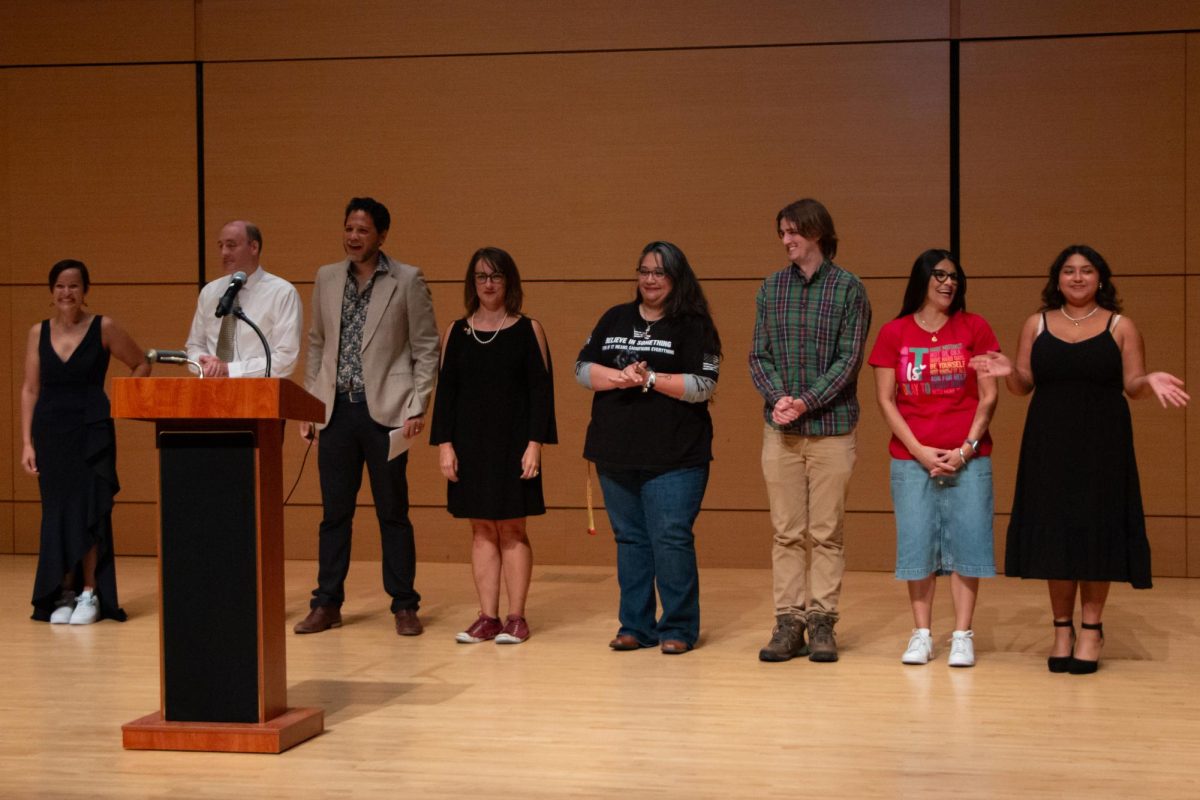 (From Left to Right) Star Stories Speakers Jessica Ary, Mason Murphy, Sergio Carvajal-Leoni, Erika Nielson, Regina Nelson, Sean O’Connor, Monica Charles and Felicia Ramos gather on stage for a group photo, Wednesday, Oct. 23, 2024, at the Performing Arts Center. Star Stories is an event where speakers share inspiring stories.