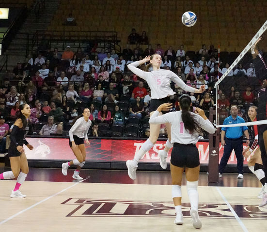 Junior middle blocker Jade Defraeye (5) rises up to spike the ball during the game versus Arkansas State, Saturday, Oct. 19, 2024, at Strahan Arena.