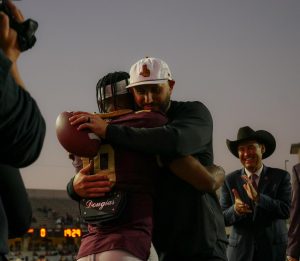 Texas State Head Coach G.J. Kinne and senior safety Kuga Culp (19) hug on Senior Night during the Texas State vs. Georgia State football game on Saturday, Nov. 23, 2024, at UFCU Stadium.