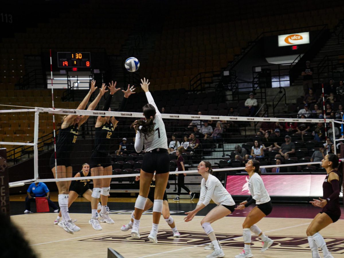 Texas State outside hitter M.J. McCurdy (7) tips the ball over the net during the game versus Southern Miss, Saturday, Nov. 2, 2024, at Strahan Arena.