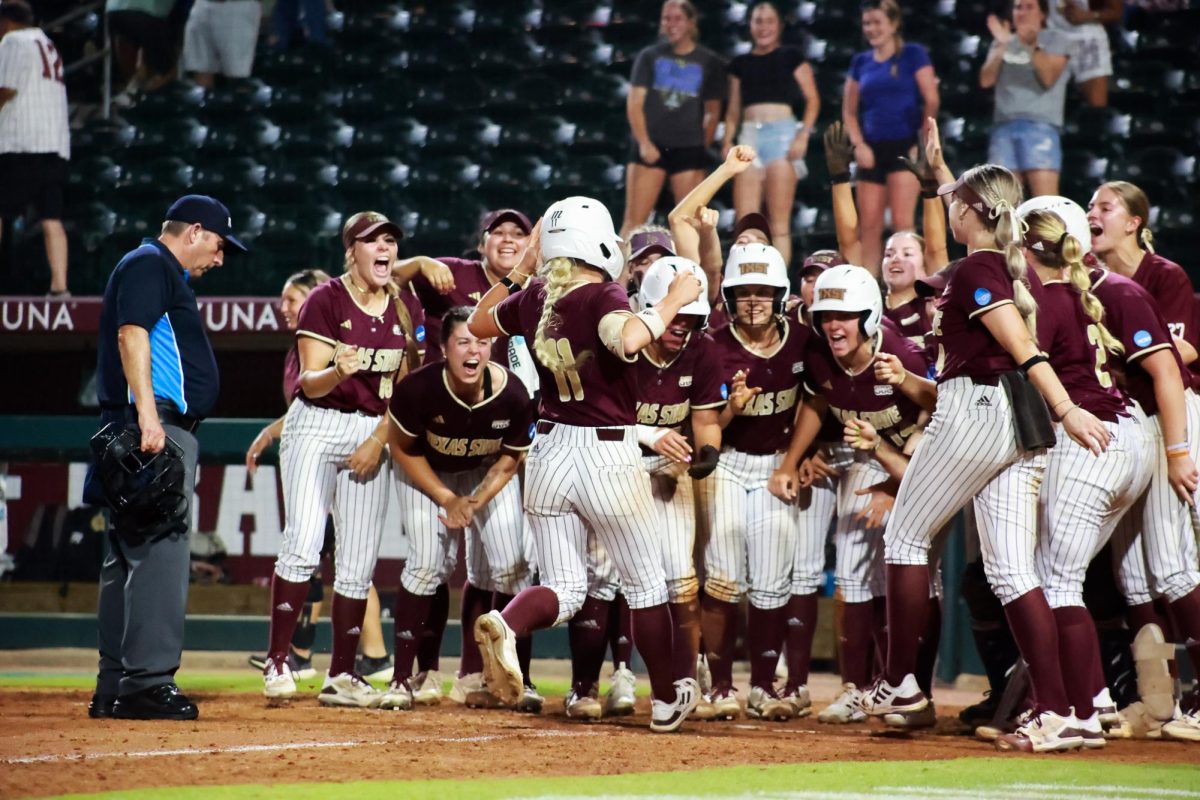 Texas State senior outfielder Piper Randolph (11) meets her teammates at home base to celebrate hitting a home run during the game against Penn State at the NCAA Regionals Tournament, Saturday, May 18, 2024, at Davis Diamond in College Station, Texas.