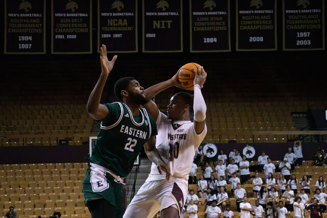 Texas State senior forward Christian Turner (30) keeps the ball away from an Eastern Michigan defender, Monday, Nov. 11, 2024, at Strahan Arena.