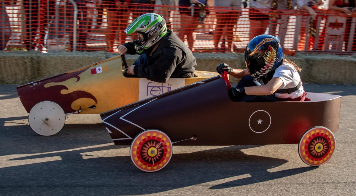 The Division of Marketing and Communication falls slightly behind Kappa Alpha Order Fraternity as they compete in the Homecoming Soap Box Derby, Friday, Nov. 15, 2024, on Woods Street.