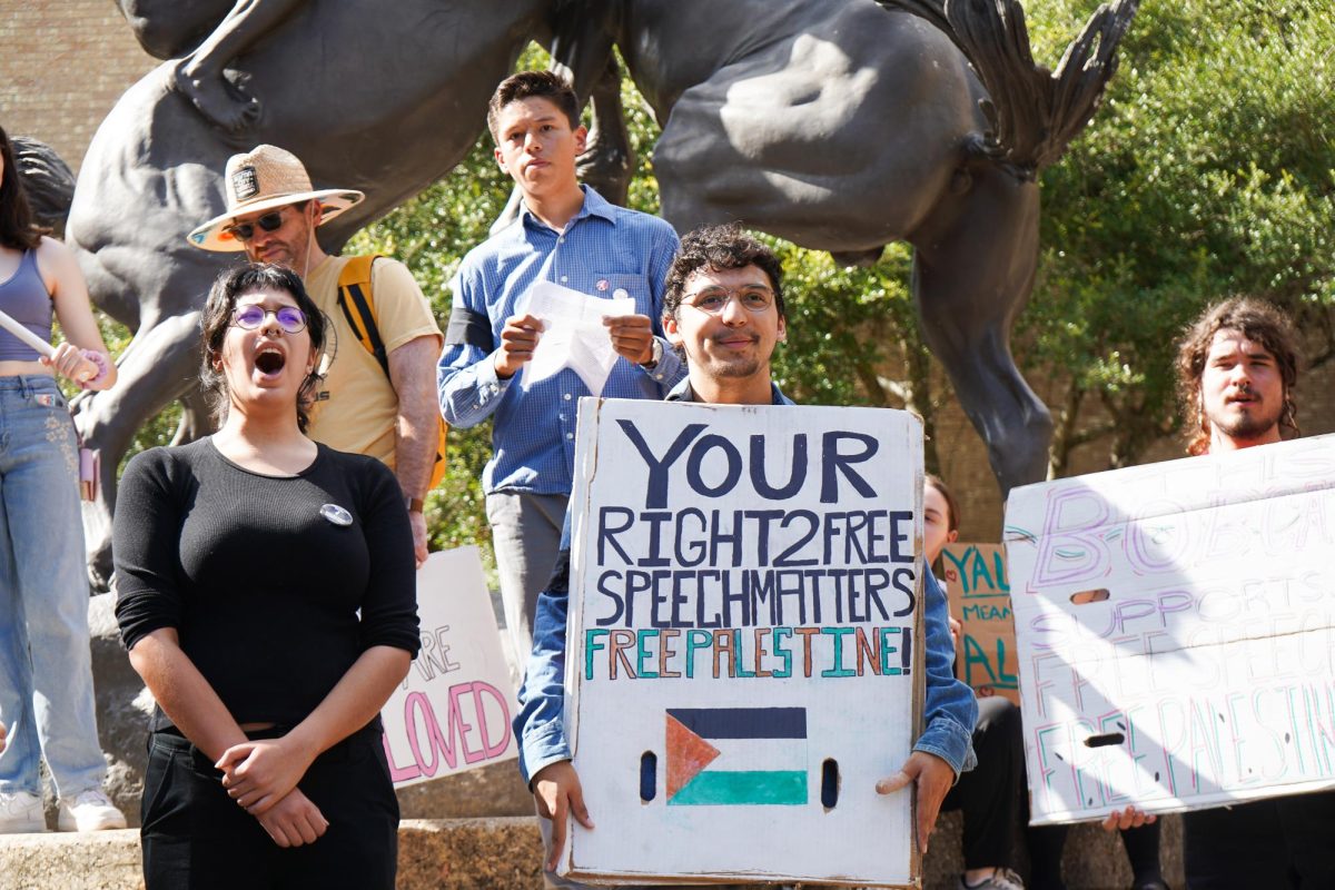 Students hold signs for a free Palestine, Wednesday, Nov. 13, 2024, at the Stallions.