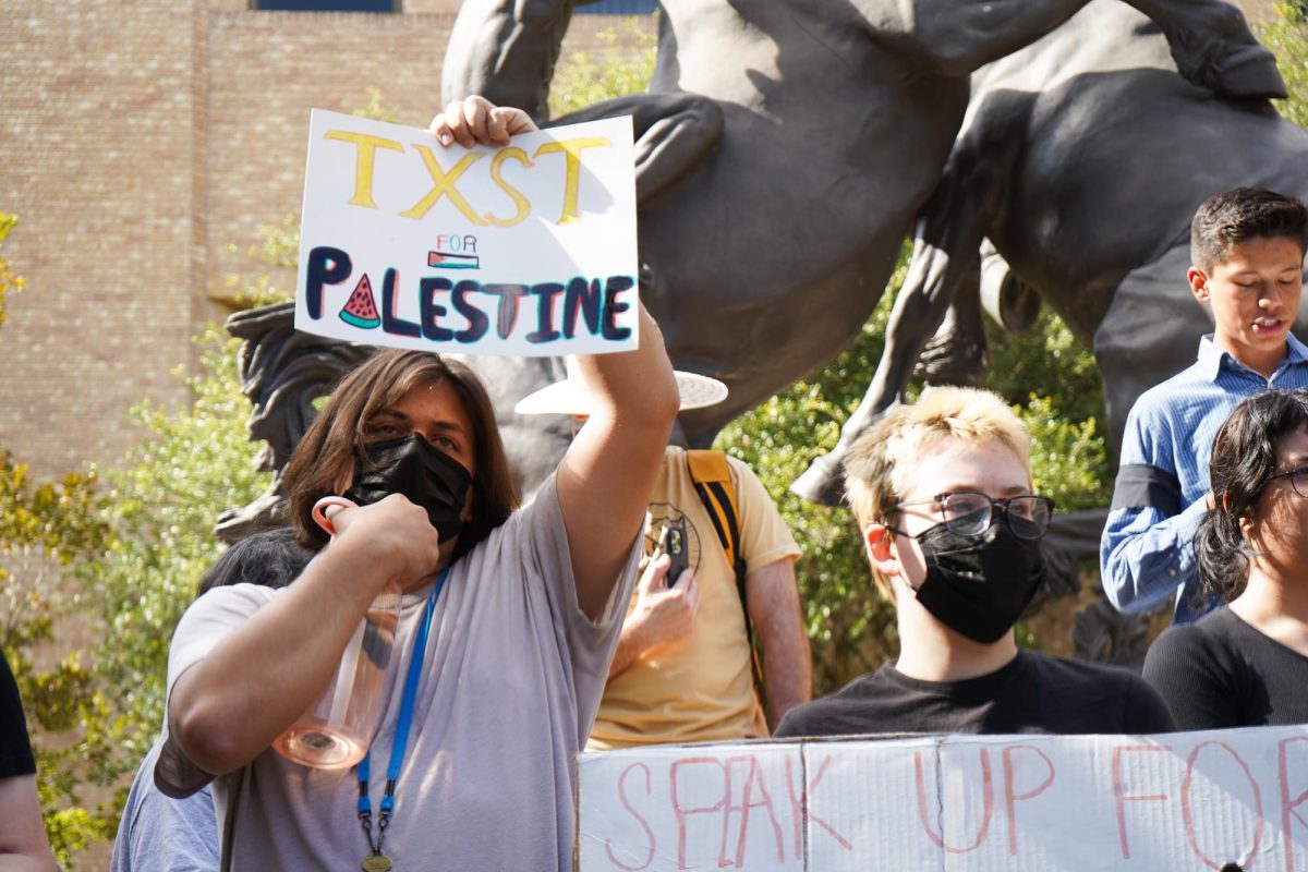 A student holds a sign for Palestinian support, Wednesday, Nov. 13, 2024, at the Stallions. 