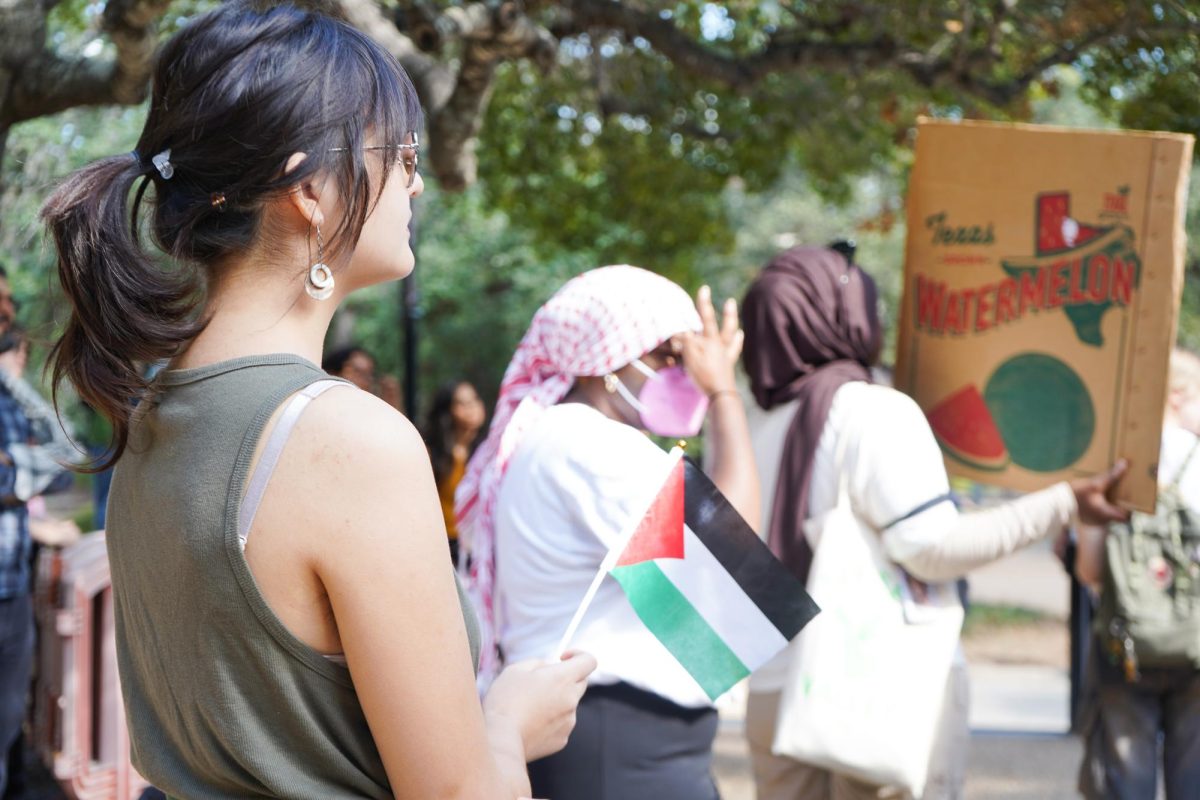 A student holds the Palestinian flag, Wednesday, Nov. 13, 2024, at the Stallions. 