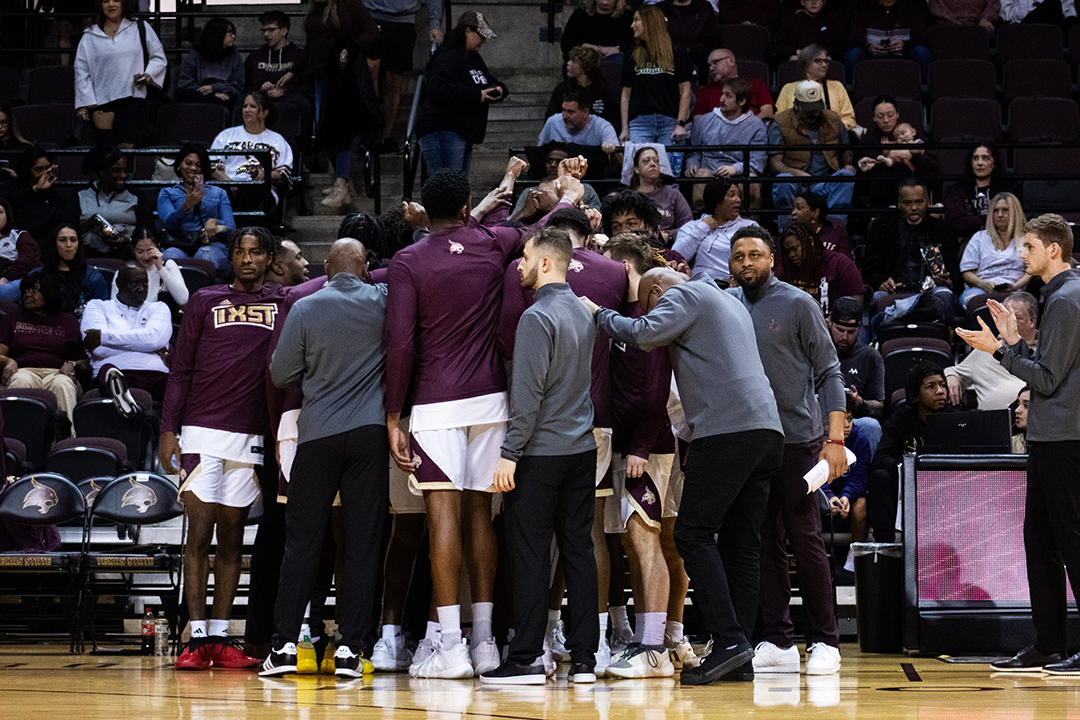 The Texas State men’s basketball team huddles together before the game against Marshall, Saturday, Jan. 6, 2024, at Strahan Arena.