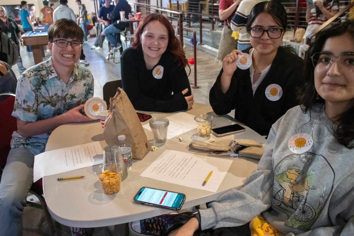 (Left to Right) Electrical engineering freshman Cody Kostencki, psychology freshman Helaina Holder, criminal justice freshman Ashley Gomez, and psychology freshman Nasseem Vares represent the political science department while attending the 2024 election watch party, Tuesday, Nov. 5, 2024, at George's.