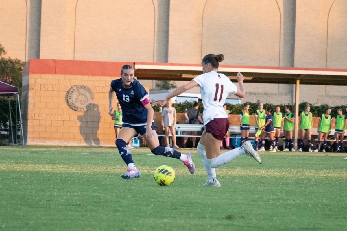 Texas State junior midfielder Lily Erb (11) kicks the ball past a Georgia Southern defender. Thursday, Oct. 31, 2024, at Bobcat Soccer Complex.