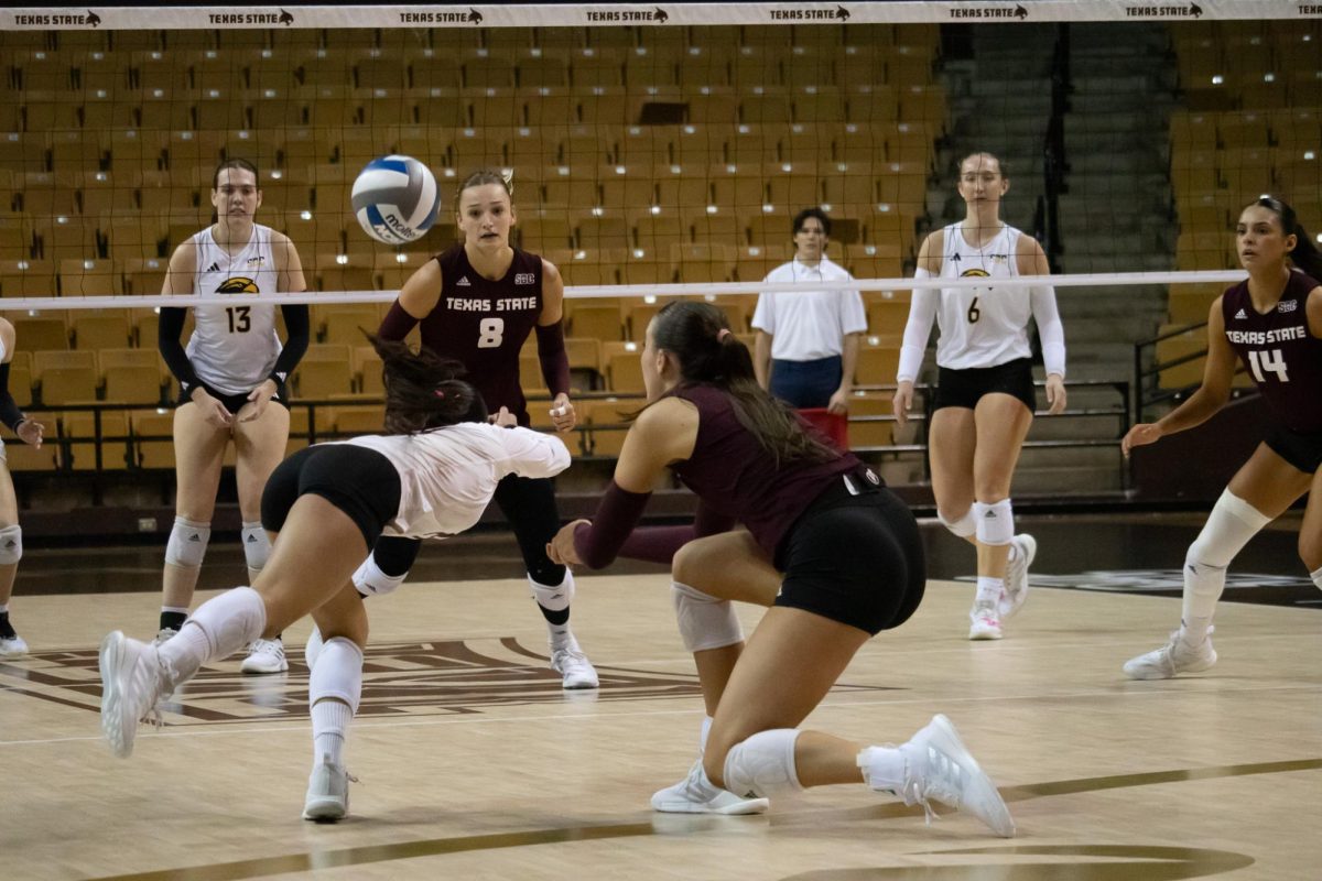 Texas State senior libero Alyssa Ortega (21) dives for the ball during the match against Southern Miss Friday, Nov. 1, 2024, at Strahan Arena.