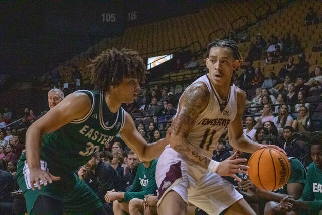 Texas State sophomore guard Kaden Gumbs (11) attempts to dribble past an Eastern Michigan defender, Monday, Nov. 11, 2024, at Strahan Arena.