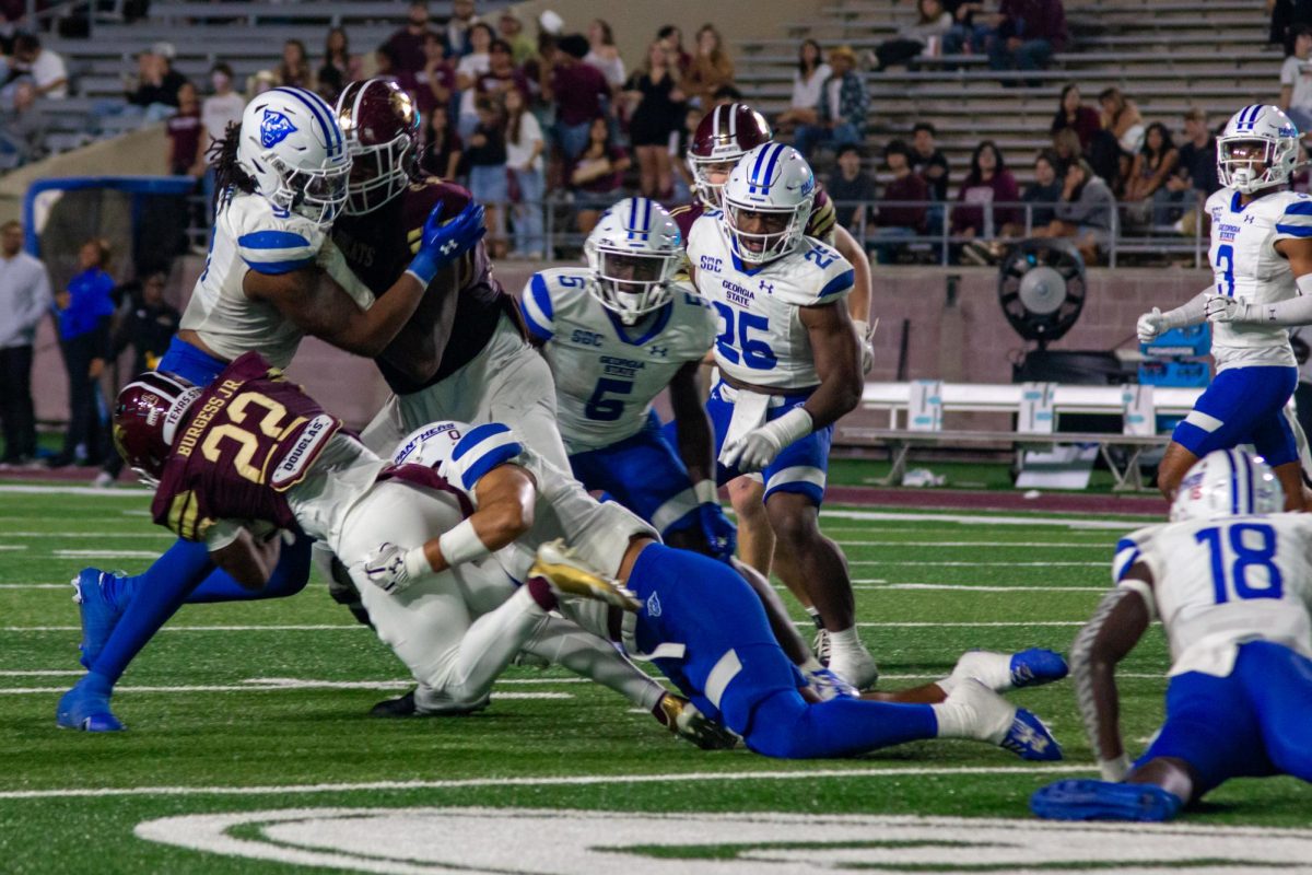 Running back Torrance Burgess Jr. (22) gets tackled while rushing the football during the game against Georgia State University, Saturday, Nov. 23, 2024, at UFCU Stadium.