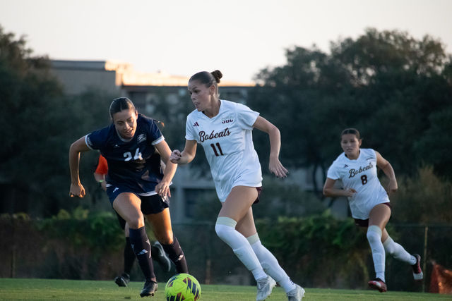 Texas State junior midfielder Lily Erb (11) keeps the ball away from a Georgia Southern defender, Thursday, Oct. 31, 2024, at Bobcat Soccer Complex.