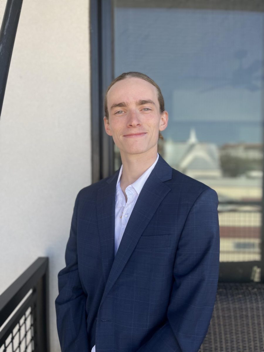 Sports Reporter Brendan Fielding stands on a balcony soaking in downtown San Marcos vibes on Monday, Dec. 2, 2024.