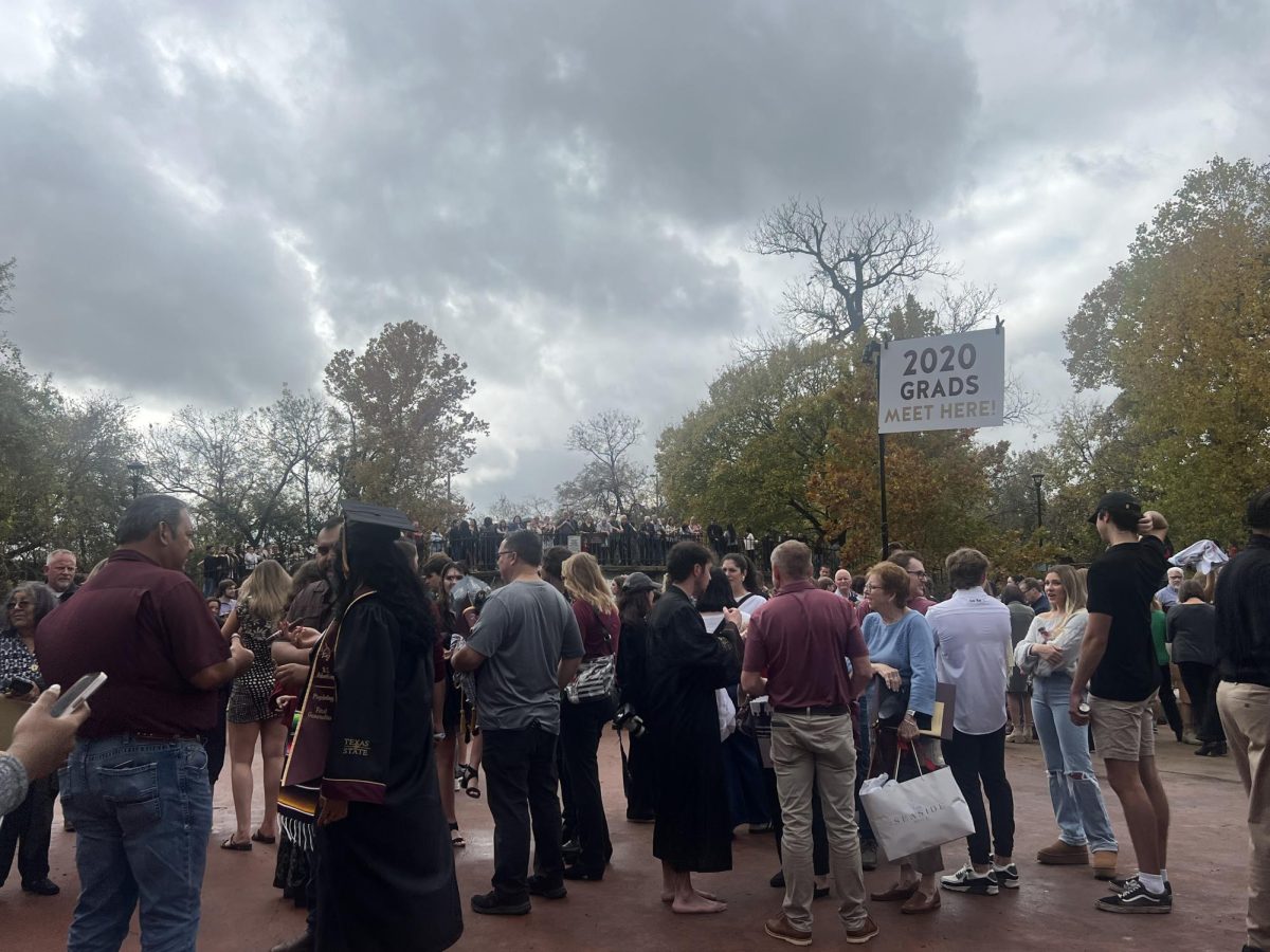 2020 graduates meet at a designated area to gather with their families and take pictures, Saturday, Dec. 14, 2024, at Sewell Park.