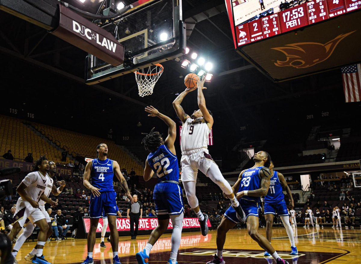 Texas State senior forward Tylan Pope (9) shoots the ball against Georgia State on Wednesday, Jan. 15, 2025, at Strahan Arena.