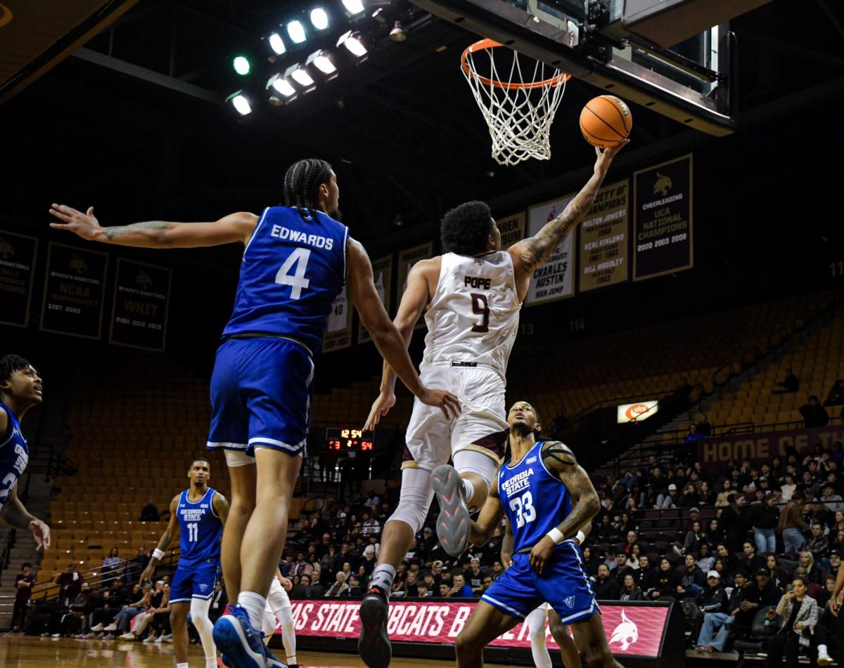 Texas State senior forward Tylan Pope (9) shoots the ball against Georgia State on Wednesday, Jan. 15, 2025, at Strahan Arena.