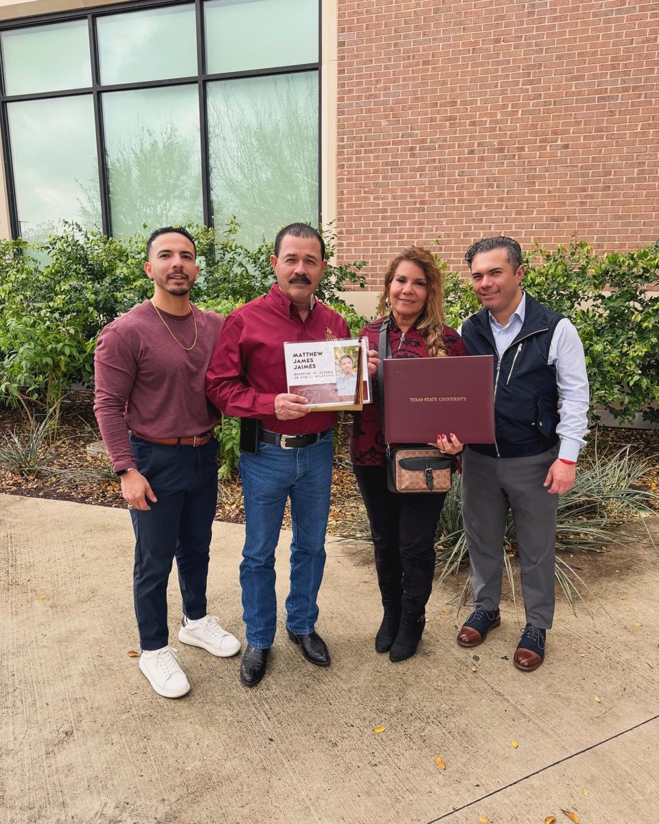 (From Left to Right) Mark, Henry, Julie, and Michael Jaimes stand with images of Matthew Jaimes and his degree, Saturday, Dec. 14, 2024, at Strahan Arena. Photo courtesy of Rene Aguirre.