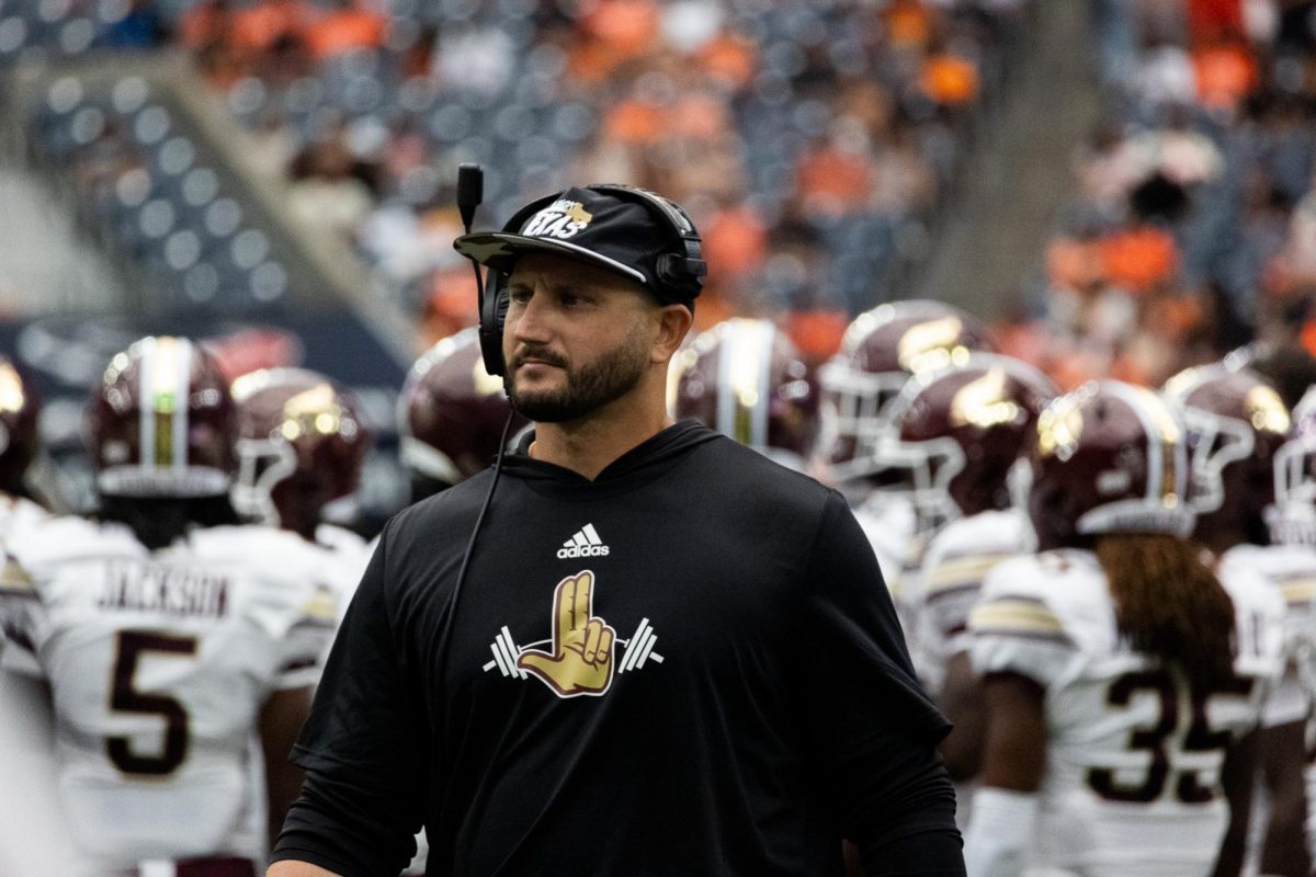 Texas State football coach GJ Kinne walks back to the sidelines after a timeout during the game against Sam Houston State, Saturday, Sept. 28, 2024, at NRG Stadium in Houston.