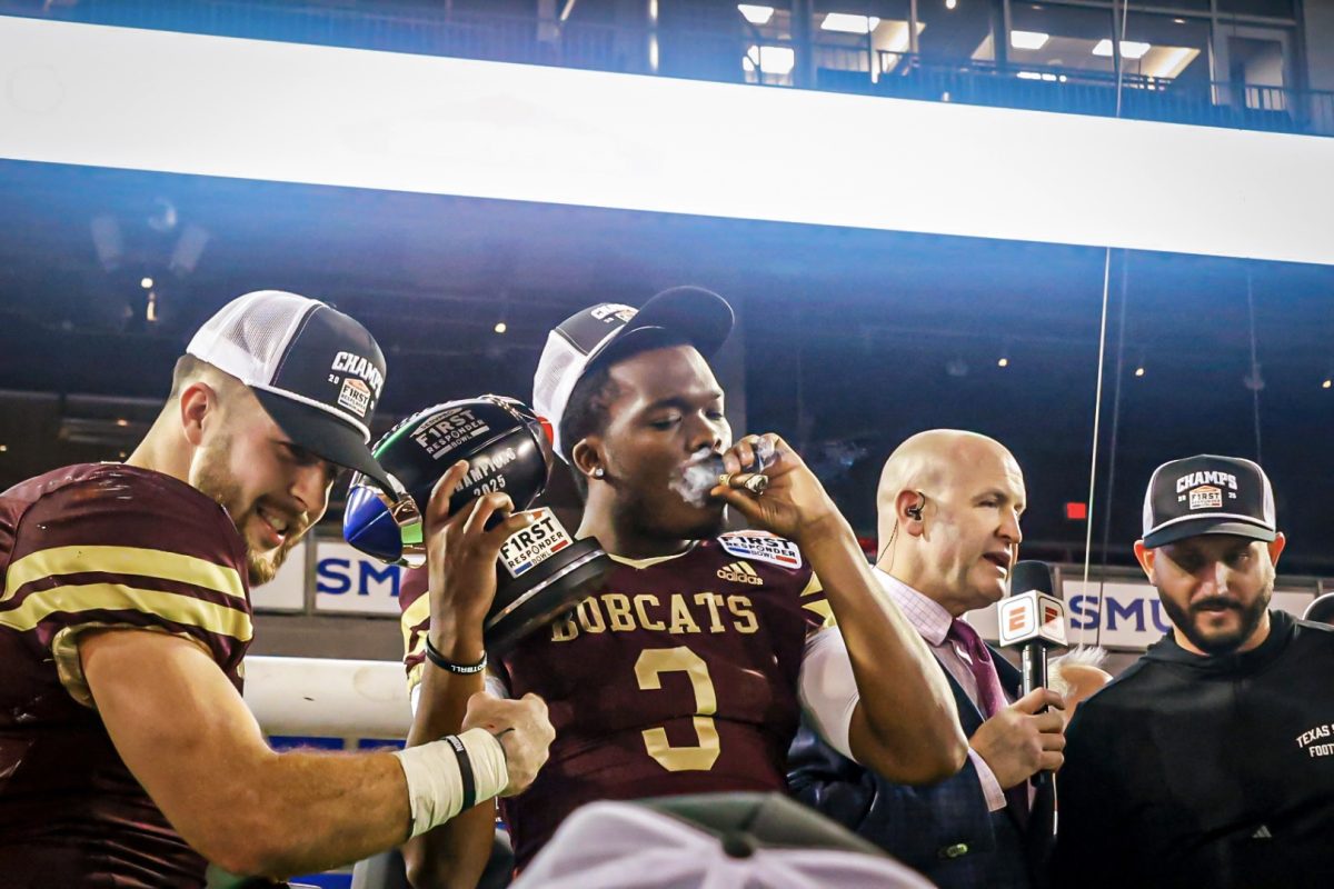 Texas State redshirt senior quarterback Jordan McCloud (3) holds the SERVPRO First Responder Bowl trophy after the win against North Texas, Friday, Jan. 3, 2025 at Gerald J. Ford Stadium.