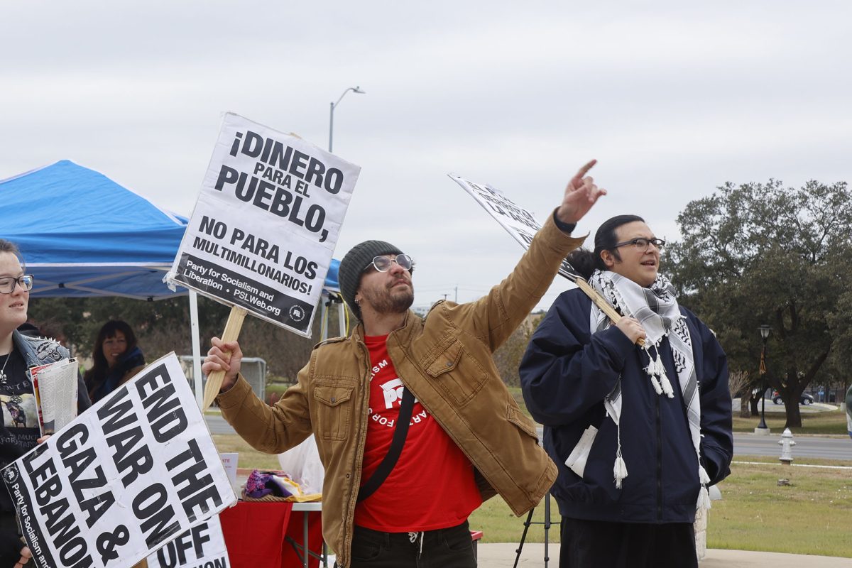 Party of Socialism and Liberation member Jack, holds up a sign during the rally, Monday, Jan. 20, 2025, at San Marcos City Hall.