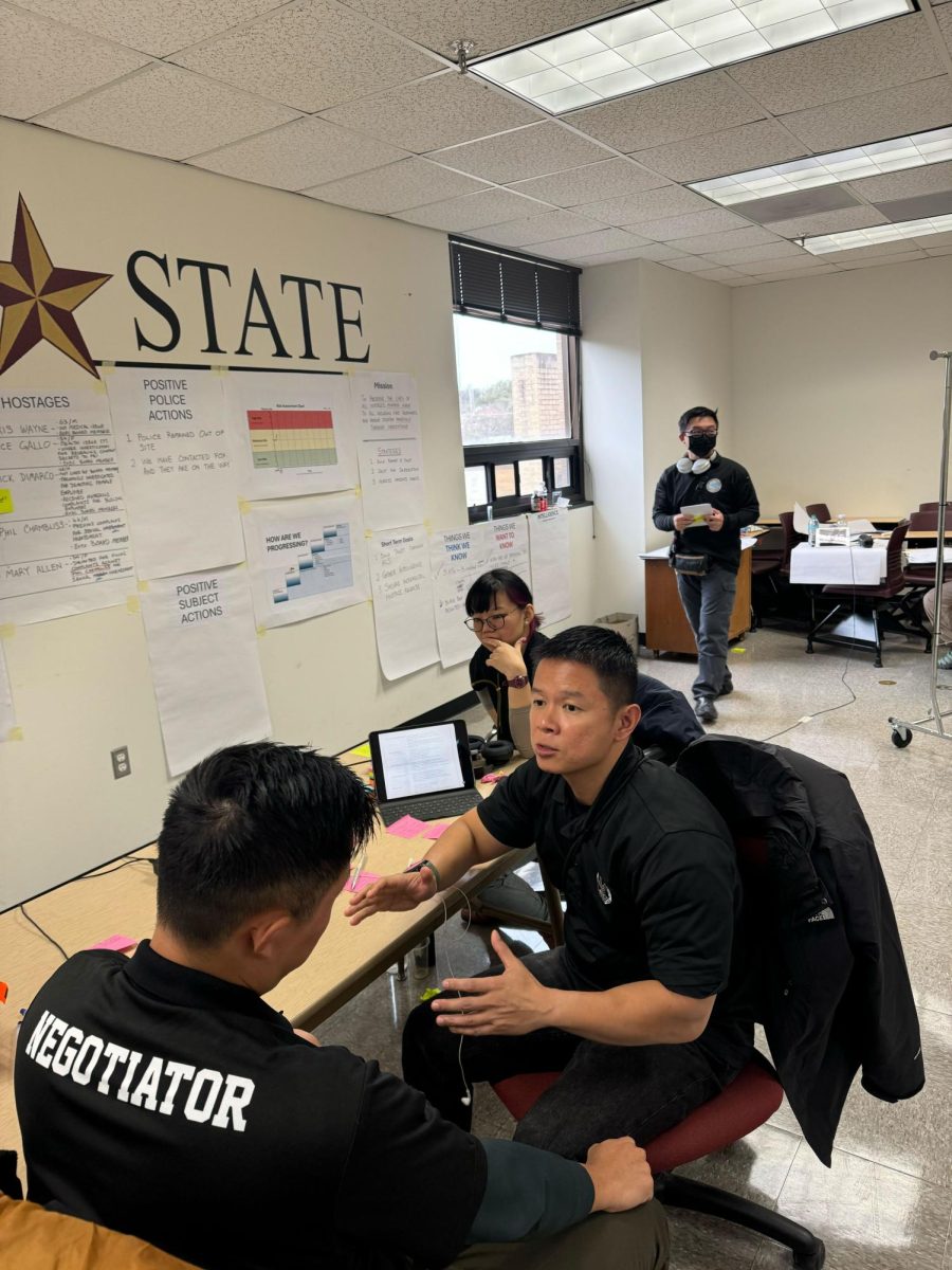 Two members of the Singaporean negotiation team strategize ahead of the call with the hostage taker on Wednesday, Jan. 8 at Texas State.