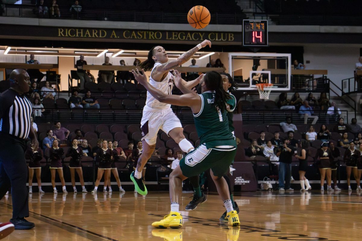 Texas State sophomore guard Kaden Gumbs (11) passes the ball over his Eastern Michigan defender's head. Monday, Nov. 11, 2024 at Strahan Arena.