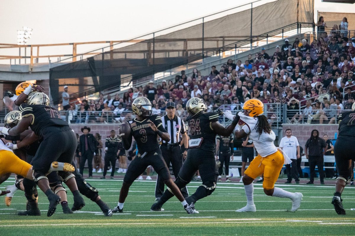 Texas State redshirt senior quarterback Jordan McCloud (3) looks to pass the ball before Arizona State defenders reach him, Thursday, Sept. 12, 2024, at UFCU Stadium.