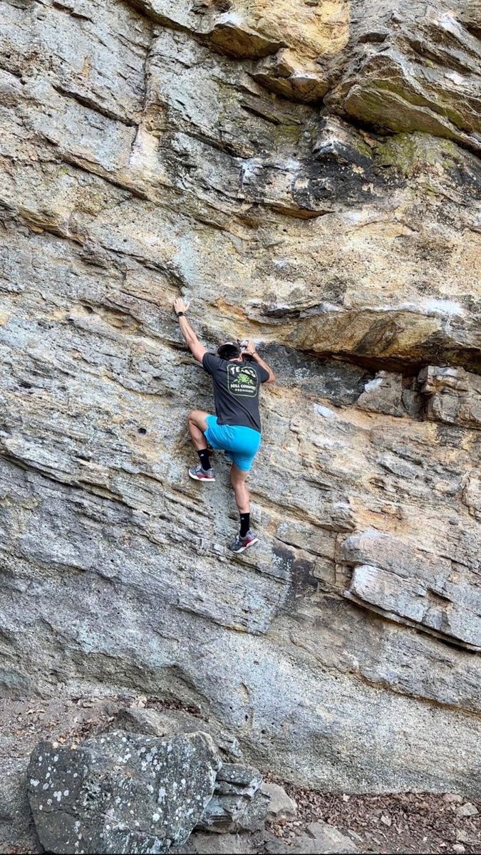 Business management alumnus John Sorsby climbs around on the rocks, Wednesday, Nov. 20, 2023, at Lake Mineral Wells State Park. Photo courtesy of John Sorsby.