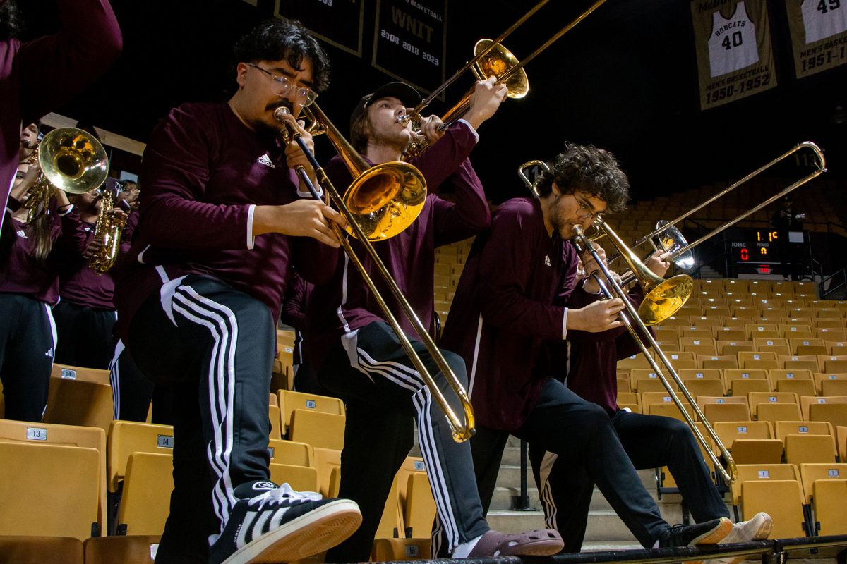 Trombone players alternate raising and lowering their instruments during a song before the men's basketball game against University of Southern Miss, Wednesday, Jan. 15, 2025, at Strahan Arena.