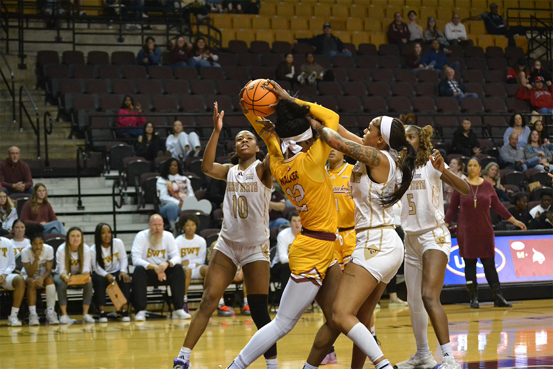 Texas State senior forward Jaylin Foster (11) tries to steal the ball from ULM junior forward Laila Walker (12), Saturday, Jan. 25, 2025, at Strahan Arena.