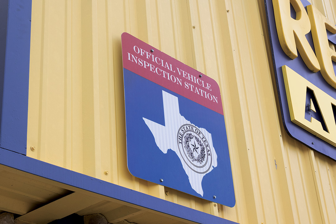 State inspection sign sits outside of Reliable Automotive, Wednesday, Jan. 8, 2024, in San Marcos.