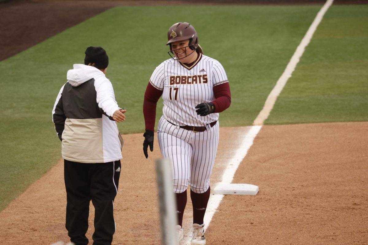 Aiyana Coleman (17) goes to high-five softball head coach Ricci Woodard while finishing her home run trot during the game against Stephan F. Austin, Thursday, Feb. 13, 2025, at Bobcat Softball Stadium. Bobcats beat the Lumberjacks 3-1.