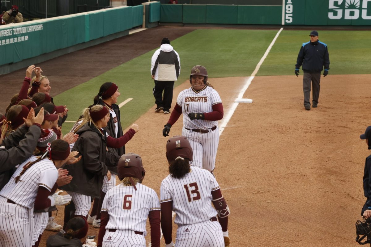 Texas State softball cheers on infielder Aiyana Coleman (17) as she finishes her home run during the game against Stephan F. Austin, Thursday, Feb. 13, 2025, at Bobcat Softball Stadium. Bobcats beat the Lumberjacks 3-1.