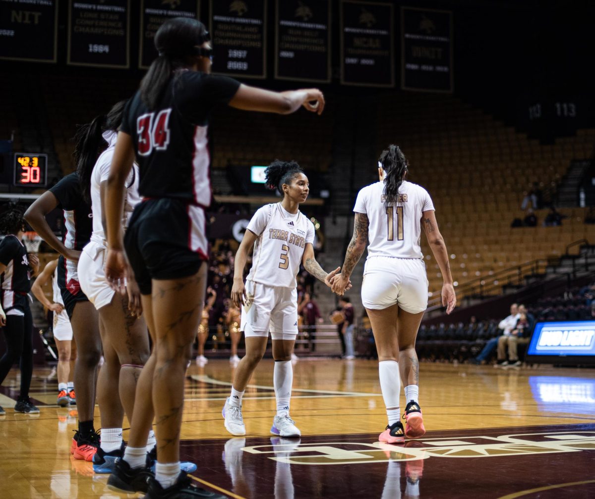 Senior #3 Crystal Smith and Accounting Senior #11 Jaylin Foster high-five each other at the game against the Ragin' Cajuns on Feb 19, 2025.