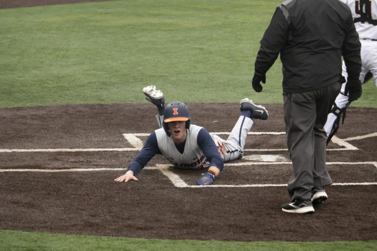 University of Illinois senior center fielder Nick Groves (29) slides into home base at the beginning of the second inning, Saturday, Feb. 22, 2025 at Bobcat Ballpark. University of Illinois beat Texas State 15-3.