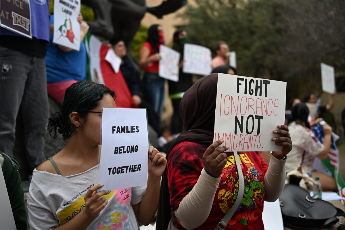 Students hold signs protesting ICE and immigration policies, Wednesday, Feb. 5, 2025, at the Stallions.