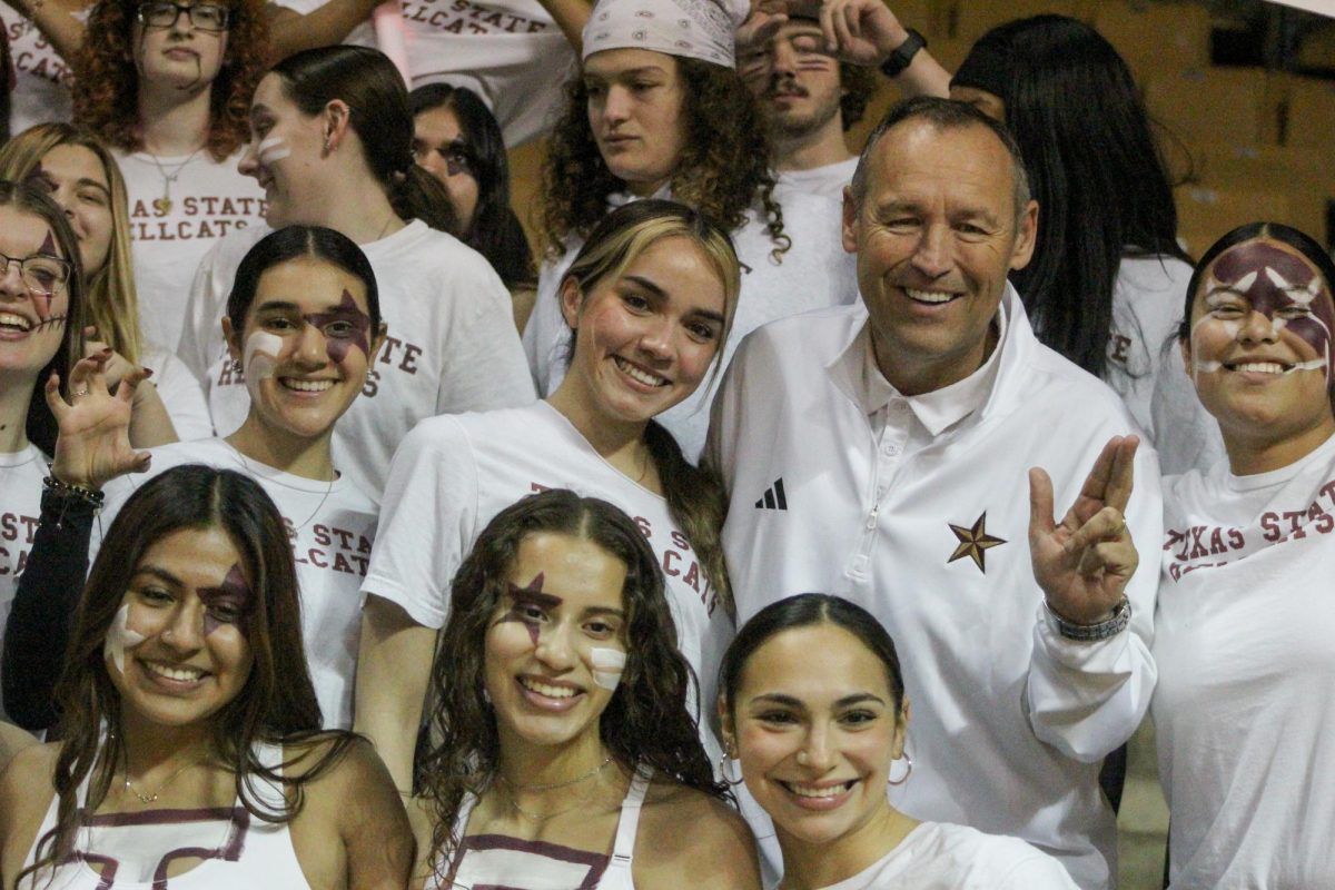 Texas State University President Kelly Damphousse poses with the Texas State Hellcats during the mens basketball game versus University of Louisiana, Thursday, Jan. 30, 2025, at Strahan Arena. The Hell Cats are a co-ed spirit fraternity that supports Texas State athletics. 